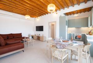 a kitchen and living room with a table and a couch at Paradissi Marmara in Cherronisos