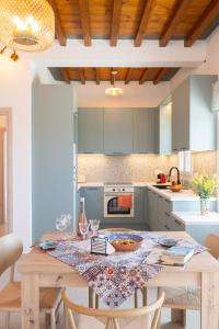 a kitchen with a wooden table with chairs around it at Paradissi Marmara in Cherronisos