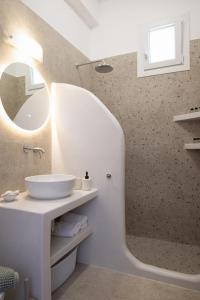 a bathroom with a sink and a mirror at Paradissi Marmara in Cherronisos +26 photos