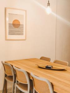 a wooden table with chairs and a surfboard on it at La Jaus by Hope in Guatapé