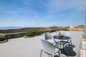 a table and chairs on a patio with a view at Paradissi Marmara in Cherronisos