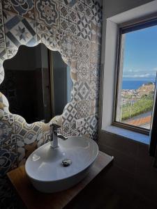 a bathroom with a sink and a large window at Tramonto di Calabria in Pizzo