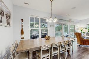 a dining room with a wooden table and chairs at 39609 Waterworks Ct in Bethany Beach