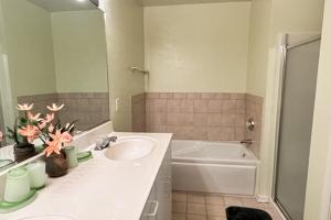 a bathroom with a sink and a bath tub at Sea Colony --- 55032 Pine Lake Dr in Bethany Beach +30 photos