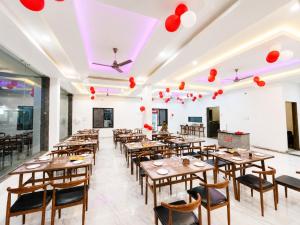 a restaurant with wooden tables and chairs and red lanterns at Hotel Virat Palace 600 From Khatu Shyam Ji in Khātu