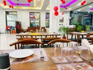 a dining room with tables and chairs and red balloons at Hotel Virat Palace 600 From Khatu Shyam Ji in Khātu +24 photos