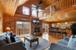 a living room with a couch and a fireplace at Little Elk Lodge in Elk Park