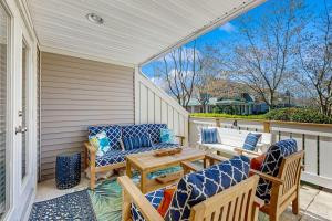 a porch with two chairs and a wooden table at Sea Colony - 55073 Pine Shore in Bethany Beach