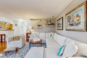 a living room with a white couch and a table at Sea Colony - 55073 Pine Shore in Bethany Beach