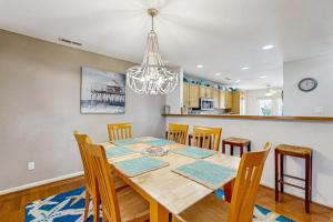a dining room table with chairs and a chandelier at Sea Colony - 55073 Pine Shore in Bethany Beach +44 photos
