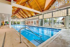 a large indoor swimming pool with a large ceiling at Bear Trap Dunes - 53 October Glory Ave in Ocean View