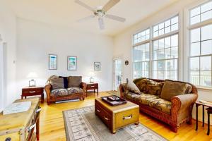 a living room with two couches and a table at Bear Trap Dunes - 53 October Glory Ave in Ocean View