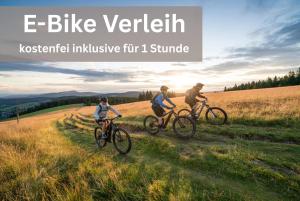 a group of three people riding bikes in a field at Grüner Baum Naturparkhotel & Schwarzwald-Restaurant in Todtnau