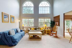 a living room with a blue couch and a table at Wedgefield - 7 Saint George in Ocean View
