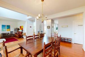 a dining room and living room with a wooden table at Wedgefield - 7 Saint George in Ocean View