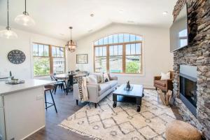 a living room with a couch and a fireplace at Franklin On Main in Blowing Rock