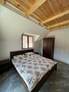a bedroom with a bed in a room with a window at Etno village Bare in Bare +32 photos