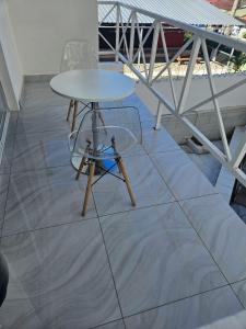 a table and two chairs on a tile floor at Modern Tropical Oasis in Sosúa