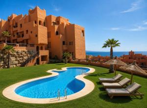 a resort with a swimming pool in front of a building at Duquesa Coto Real in Manilva