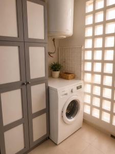 a laundry room with a washing machine and a window at Duquesa Coto Real in Manilva