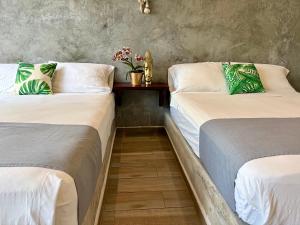 two beds sitting next to each other in a room at Hotel Lunazul In Costa Esmeralda in La Vigueta +34 photos