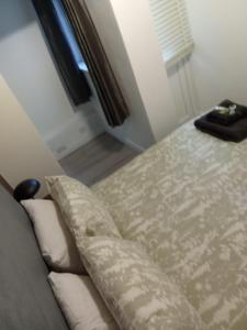 a bed in a room with a couch and a window at Swannery Vista 1 Bedroom Apartment in Weymouth