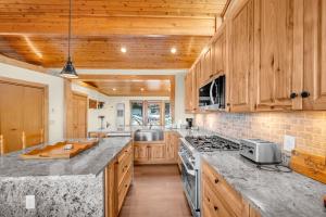 a kitchen with wooden cabinets and granite counter tops at Soaring Eagles View in Beech Mountain +35 photos