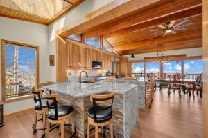 a kitchen with a large stone island with a sink at Soaring Eagles View in Beech Mountain