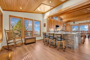 a kitchen with a large island with bar stools at Soaring Eagles View in Beech Mountain