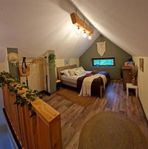 a bedroom with a bed in a attic at Domek na Folwarku z jacuzzi in Tarnawa Dolna