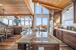 a kitchen with wooden ceilings and a large counter top at On The Rocks Straight Up in Beech Mountain