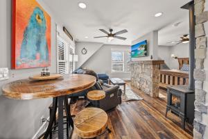 a living room with a table and a fireplace at On The Rocks Straight Up in Beech Mountain +40 photos