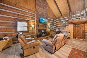 a living room with two chairs and a fireplace at Creekside Cabin in Blowing Rock