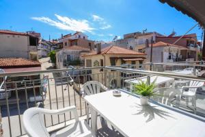 a balcony with a table and chairs and buildings at Soluna Studios in Polychrono