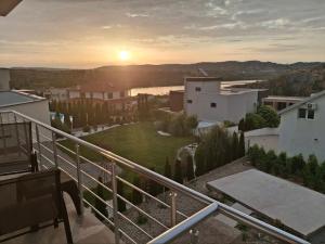 a view of the sunset from a balcony of a house at Vesna Lake Apartments in Veles