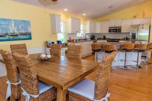 a kitchen with a wooden table and chairs at White Shell in Anna Maria