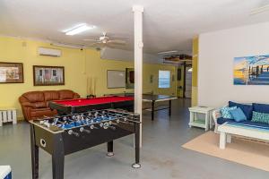 a living room with a ping pong table in it at White Shell in Anna Maria