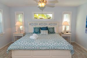 a bedroom with a large bed with two night stands at White Shell in Anna Maria