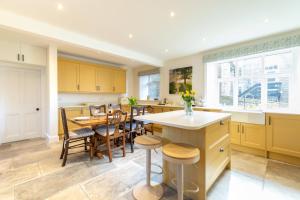 a kitchen with yellow cabinets and a table and chairs at 3 Bed in Askrigg oc-h29661 in Askrigg
