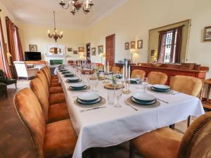 a long dining room with a long table and chairs at Bynack - Mar Lodge Estate in Ballater