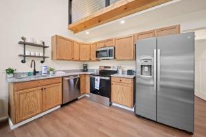 a kitchen with stainless steel appliances and wooden cabinets at Appalachian Cottage in Blowing Rock +12 photos