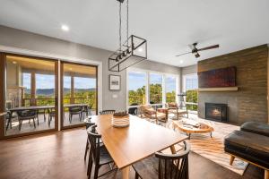 a living room with a table and a fireplace at Majestic Meadows in Boone