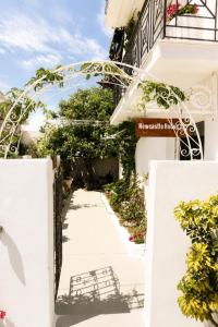a walkway to a hotel in positanoolisolisolisolisolisolisolis at Newcastle House in Skiathos