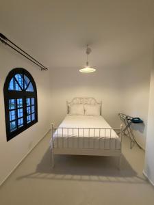 a white bed in a room with a window at Soumaya plage appartement in Fnidek