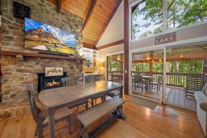 a dining room with a stone wall and a fireplace at Lake Hills Hideaway in Wilkesboro