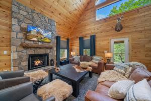a living room with a stone fireplace at Pine Ridge Retreat in Beech Mountain