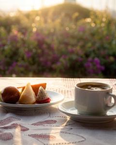 a cup of coffee and a plate of food on a table at Hotel D'Italia in Arroio do Sal +31 photos