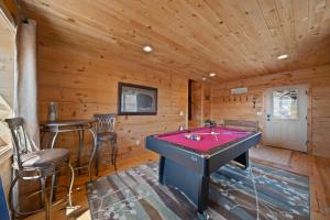 a room with a pool table in a cabin at Western Wonder in Beech Mountain