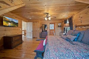 a bedroom with a bed in a room with wooden walls at Western Wonder in Beech Mountain +32 photos