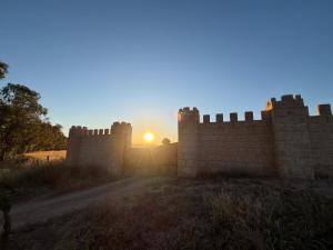a brick wall with the sunset in the background at 1001-Nights Palace in Nebeur